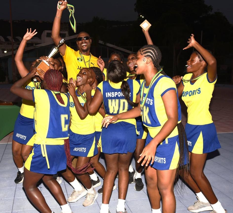 José Martí netball team lifting the trophy after their Insport Challenge Cup win